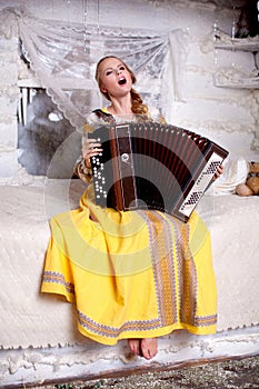 The girl sings and plays the accordion