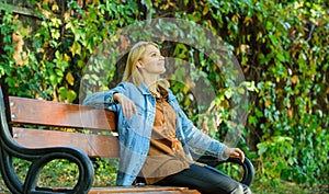 Girl sit bench relaxing fall nature background. Feeling free and relaxed. Woman blonde take break relaxing in park. You