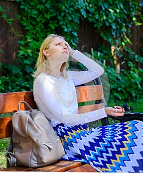 Girl sit bench relaxing in shadow, green nature background. Woman blonde take break relaxing in park. Why you deserve