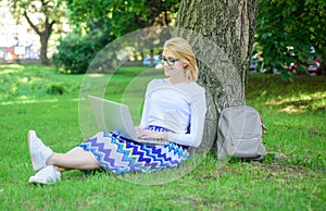 Girl sit grass lean tree trunk with notebook. Wi fi network connection free access. Lady freelancer working in park