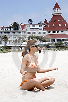 Girl siting on sand photo