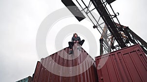 The girl sits on a freight container