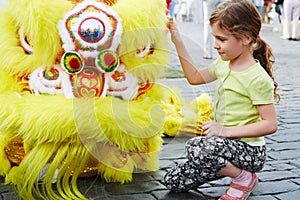 Girl sits near to dragon