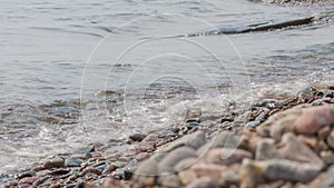 Girl sits on the shore of Baikal.