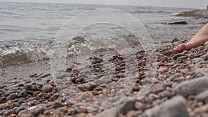 Girl sits on the shore of Baikal.