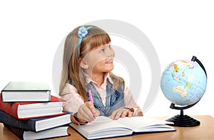 Girl sits at a table and writes