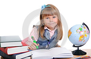 Girl sits at a table and writes