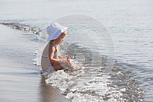 Girl sits at the water's edge