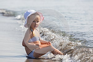 Girl sits at the water's edge