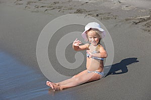 Girl sits at the water's edge