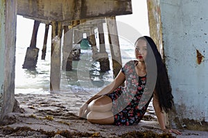 Girl sitting above the pier