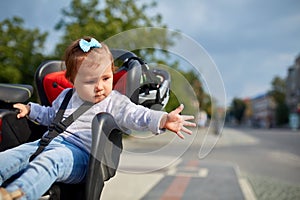 Girl sitting in a baby bike seat of a bicycle of her father safety emotions anxiety kids children parenting.