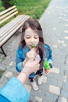 Girl sitting on bench with candies