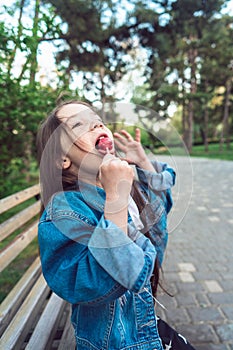 Girl sitting on bench with candies