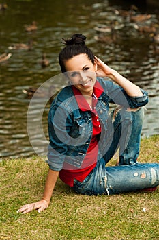 girl sitting on a bench in a green summer garden