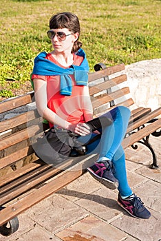 Girl sitting on a bench near the sea