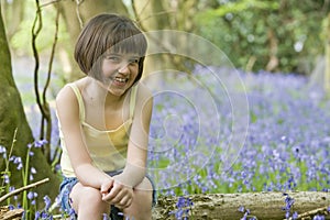 Girl sitting in bluebells