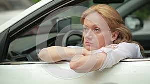 Girl sitting in the car in the rain. the driver waits for passengers