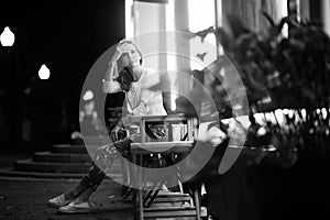 Girl sitting in a chair at night