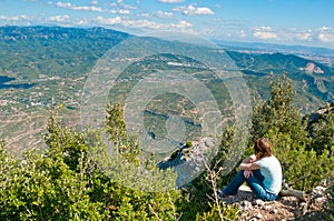 Girl sitting on a cliff