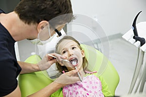 Girl sitting on dental chair on her regular dental checkup