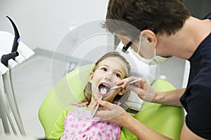 Girl sitting on dental chair on her regular dental checkup