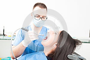 Girl sitting in dentist chair having a professional brushing fro