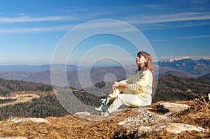 Girl sitting on the edge of a cliff