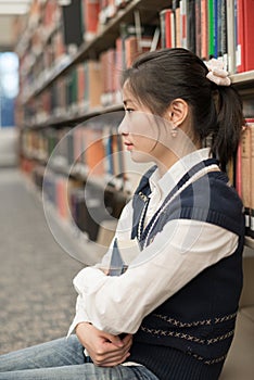 Girl sitting on the floor holding book