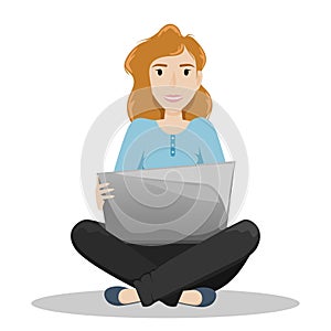 Girl sitting on a floor in a Lotus position with a laptop on her knees. Freelance. Remote work