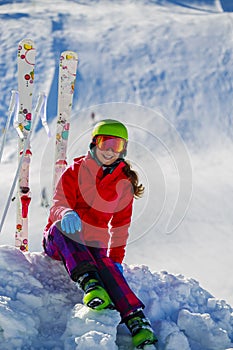 Girl sitting on the fresh powder snow.