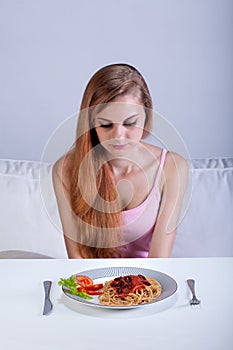 Girl sitting in front of dinner plate