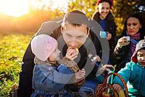 Girl sitting on the grass with an apple in his hand