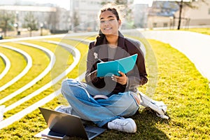 Girl Sitting on Grass With Laptop, Doing Homework