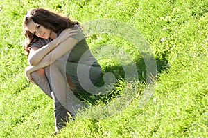 Girl sitting on green grass