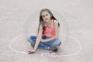 Girl sitting on the ground and drawing personal space