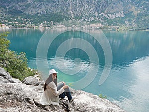 Girl sitting on the hill in the adriatic sea