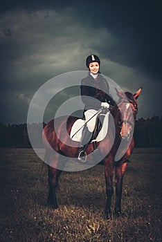 Girl sitting on a horse outdoors