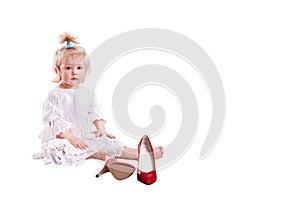 Girl is sitting infornt of women red shoes and cant decide what to do