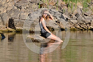 Girl sitting in lake