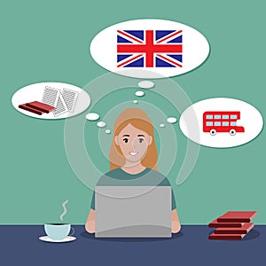 The girl is sitting at a laptop and studying English online. A gracious girl sits at a table with tea and books. English flag