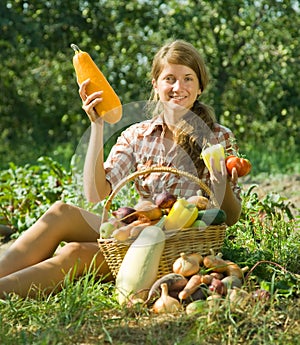 Girl sitting near basket of harvest