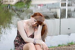 Girl sitting near lake