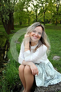 Girl sitting near the lake