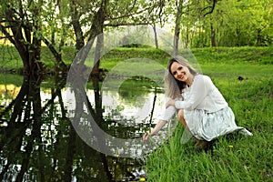 Girl sitting near the lake