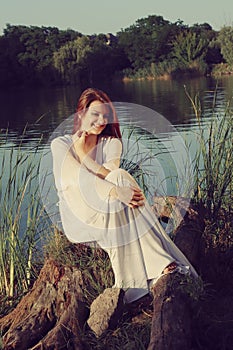 Girl sitting near lake