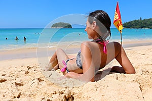 Girl sitting near sea on Kata beach