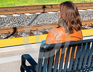 Girl Sitting Near Train Rails