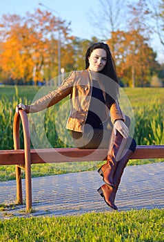girl sitting outdoor in autumn scenery