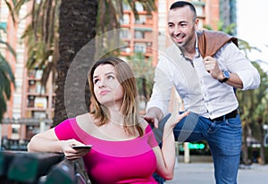 Girl is sitting with phone and inaccessibility for stranger man